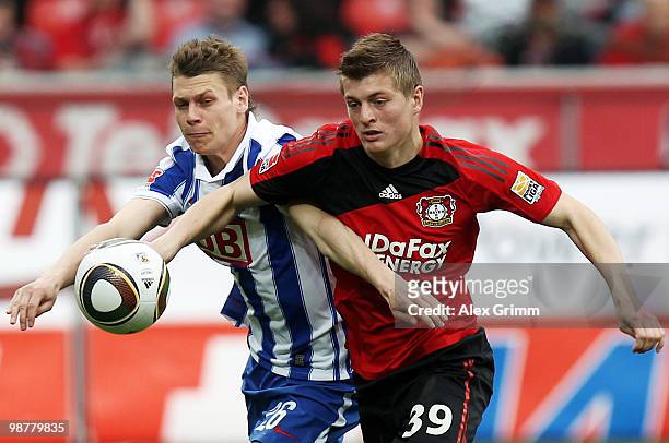 Toni Kroos of Leverkusen is challenged by Lukasz Piszczek of Berlin during the Bundesliga match between Bayer Leverkusen and Hertha BSC Berlin at the...