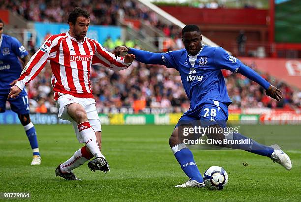 Victor Anichebe of Everton lines up a shot at goal as Danny Higginbotham of Stoke City trys to intercept during the Barclays Premier League match...