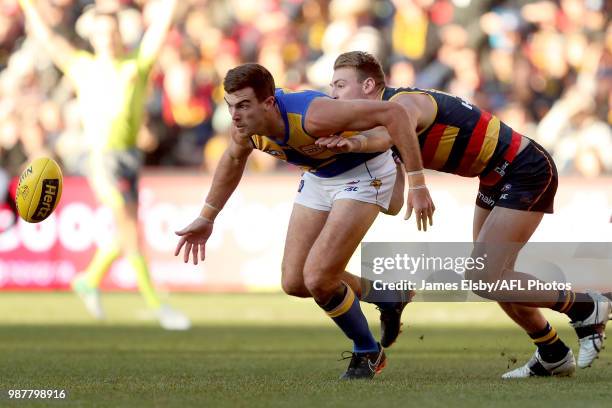 Scott Lycett of the Eagles is tackled by Daniel Talia of the Crows during the 2018 AFL round15 match between the Adelaide Crows and the West Coast...