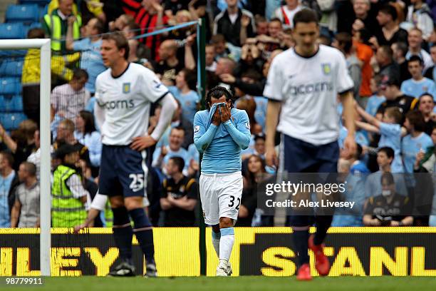 Carlos Tevez of Manchester City reacts after scoring his team's first goal from the penalty spot during the Barclays Premier League match between...