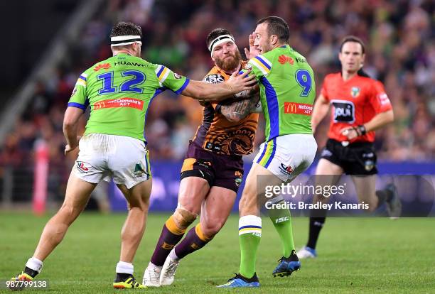 Josh McGuire of the Broncos takes on the defence during the round 16 NRL match between the Brisbane Broncos and the Canberra Raiders at Suncorp...