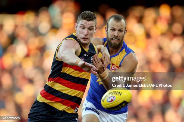 Josh Jenkins of the Crows is tackled by Will Schofield of the Eagles during the 2018 AFL round15 match between the Adelaide Crows and the West Coast...