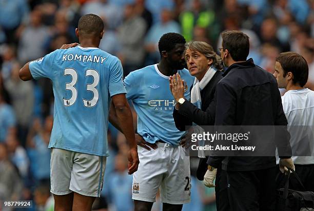 Roberto Mancini the Manchester City manager speaks with Vincent Kompany of Manchester City during the Barclays Premier League match between...