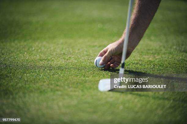 Golfer prepares his ball during the HNA Open de France as part of the European Tour 2018, at the Saint-Quentin-en-Yvelines national golf course in...