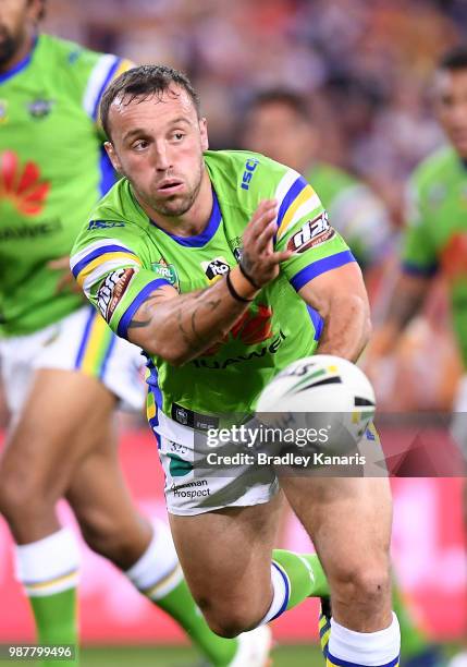 Josh Hodgson of the Raiders passes the ball during the round 16 NRL match between the Brisbane Broncos and the Canberra Raiders at Suncorp Stadium on...