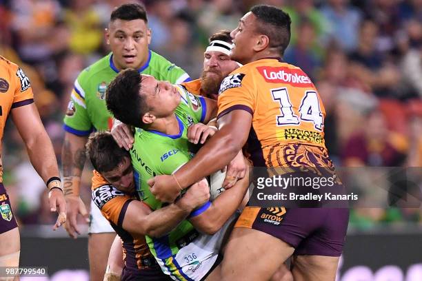 Joseph Tapine of the Raiders is tackled during the round 16 NRL match between the Brisbane Broncos and the Canberra Raiders at Suncorp Stadium on...