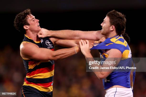 Kyle Hartigan of the Crows clashes with Jeremy McGovern of the Eagles during the 2018 AFL round15 match between the Adelaide Crows and the West Coast...