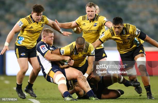 Julian Savea of the Hurricanes is tackled during the round 17 Super Rugby match between the Brumbies and the Hurricanes at GIO Stadium on June 30,...