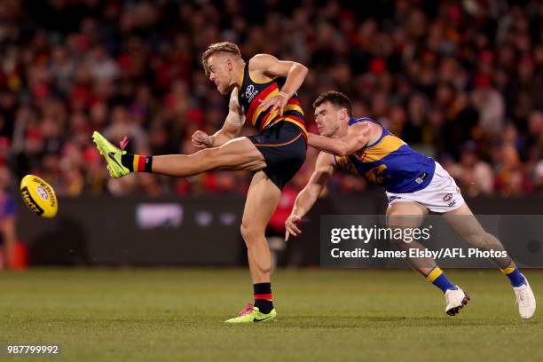 Hugh Greenwood of the Crows is tackled by Luke Shuey of the Eagles during the 2018 AFL round15 match between the Adelaide Crows and the West Coast...