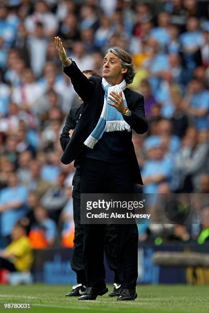 Roberto Mancini the Manchester City manager instructs his players during the Barclays Premier League match between Manchester City and Aston Villa at...