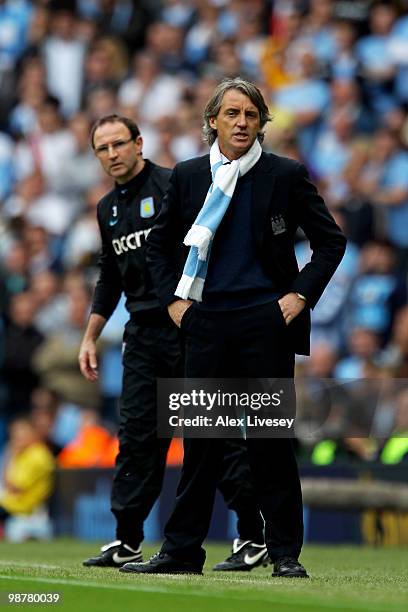 Roberto Mancini the Manchester City manager shouts instructions to his players as Martin O'Neill the Aston Villa manager looks on during the Barclays...