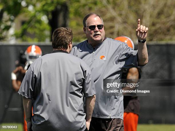 President Mike Holmgren of the Cleveland Browns talks with head coach Eric Mangini during the team's rookie and free agent mini camp on April 30,...