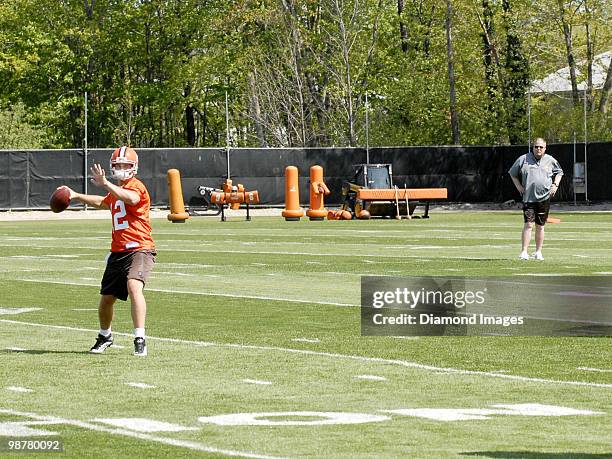 President Mike Holmgren of the Cleveland Browns watches quarterback Colt McCoy go through drills during the team's rookie and free agent mini camp on...