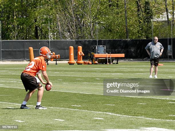 President Mike Holmgren of the Cleveland Browns watches quarterback Colt McCoy go through drills during the team's rookie and free agent mini camp on...