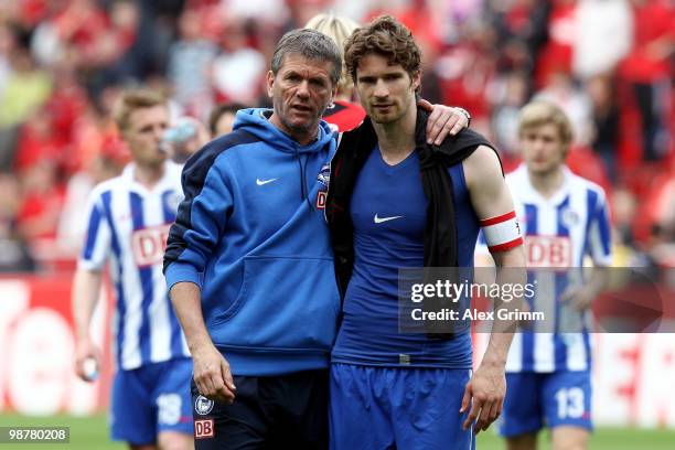 Head coach Friedhelm Funkel of Berlin and team captain Arne Friedrich walk over the pitch after the Bundesliga match between Bayer Leverkusen and...