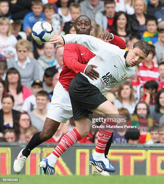 Andy Cole clashes with Alan Thompson during the United Relief charity match in aid of Sport Relief and the Manchester United Foundation between...