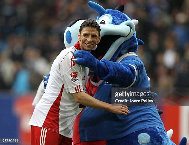 Bastian Reinhardt of Hamburg celebrates with mascot Dino of HSV after the Bundesliga match between Hamburger SV and 1. FC Nuernberg at HSH Nordbank...