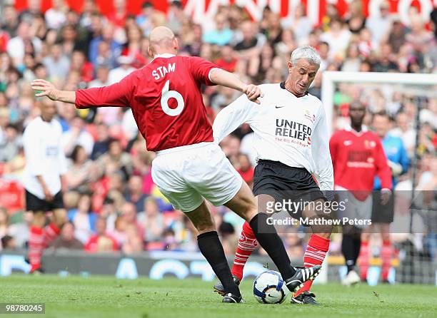 Jaap Stam clashes with Ian Rush during the United Relief charity match in aid of Sport Relief and the Manchester United Foundation between Manchester...