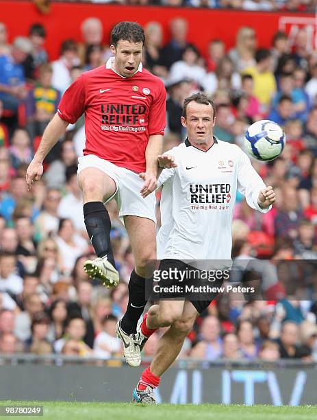 Ronny Johnsen clashes with Austin Healy during the United Relief charity match in aid of Sport Relief and the Manchester United Foundation between...
