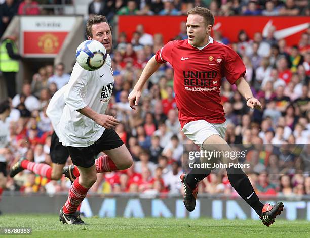 Lee Mack clashes with Olly Murs during the United Relief charity match in aid of Sport Relief and the Manchester United Foundation between Manchester...