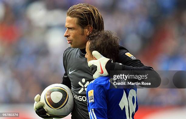 Tim Wiese , goalkeeper of Bremen comforts Rafinha of Schalke during the Bundesliga match between FC Schalke 04 and Werder Bremen at Veltins Arena May...