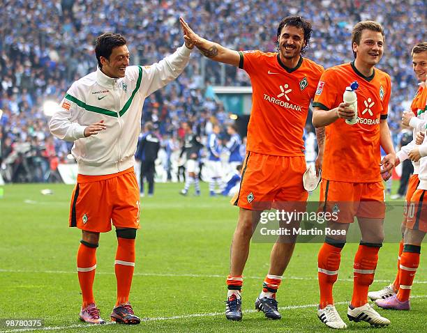 Mesut Oezil of Bremen celebrates with team mate Hugo Almeida after the Bundesliga match between FC Schalke 04 and Werder Bremen at Veltins Arena May...