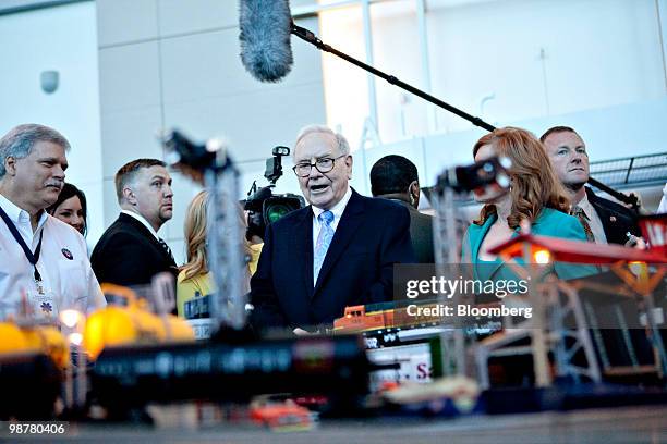 Warren Buffett, chief executive officer of Berkshire Hathaway, looks over a model train display as he tours the exhibition floor prior to the...