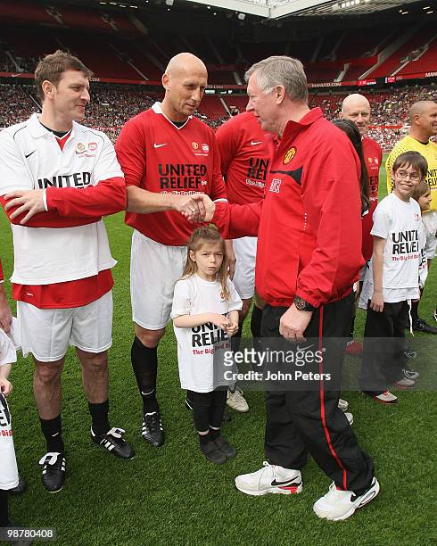 Sir Alex Ferguson shakes hands with Jaap Stam ahead of the United Relief charity match in aid of Sport Relief and the Manchester United Foundation...