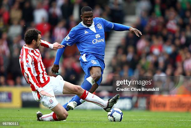 Victor Anichebe of Everton is tackled by Danny Higginbotham of Stoke City during the Barclays Premier League match between Stoke City and Everton at...