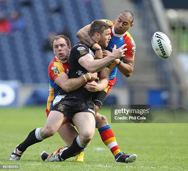 Kirk Yeaman of Hull FC is tackled by Luke Gale and Kevin Penny of Harlequins during the Engage Rugby Super League Magic Weekend match between Hull FC...