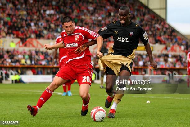 Swindon Town forward Billy Paynter battles with Brentford defender Karleigh Osbourne during the Coca Cola League One match between Swindon Town and...