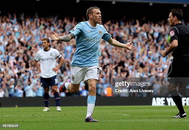 Craig Bellamy of Manchester City celebrates after scoring his team's third goal during the Barclays Premier League match between Manchester City and...