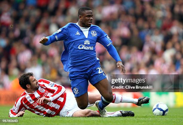 Victor Anichebe of Everton is tackled by Danny Higginbotham of Stoke City during the Barclays Premier League match between Stoke City and Everton at...