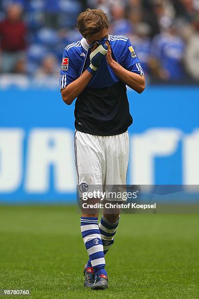 Benedikt Hoewedes of Schalke looks dejected after loosing 0-2 the Bundesliga match between FC Schalke 04 and SV Werder Bremen at Veltins Arena on May...