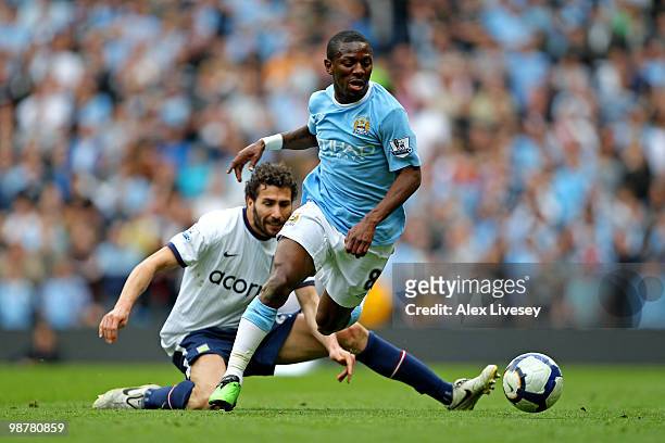 Shaun Wright-Phillips of Manchester City goes past the tackle from Carlos Cuellar of Aston Villa during the Barclays Premier League match between...
