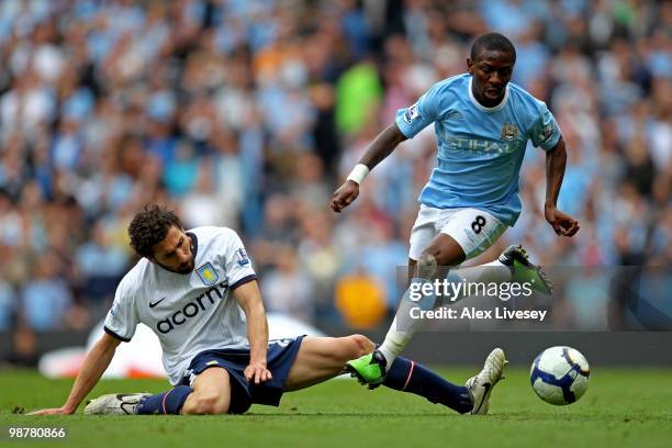 Shaun Wright-Phillips of Manchester City goes past the tackle from Carlos Cuellar of Aston Villa during the Barclays Premier League match between...