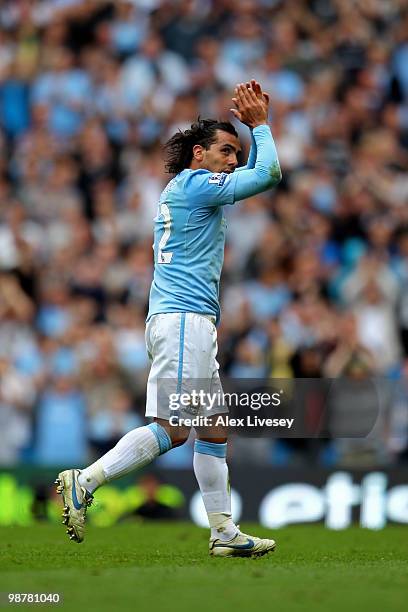 Carlos Tevez of Manchester City applauds the fans as he leaves the pitch to be substituted in the second half during the Barclays Premier League...