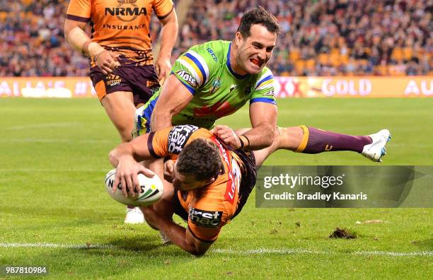 Corey Oates of the Broncos scores a try during the round 16 NRL match between the Brisbane Broncos and the Canberra Raiders at Suncorp Stadium on...