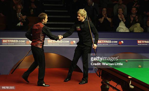 Neil Robertson of Australia is congratulated by Ali Carter of England after winning the semi final of the Betfred.com World Snooker Championships at...