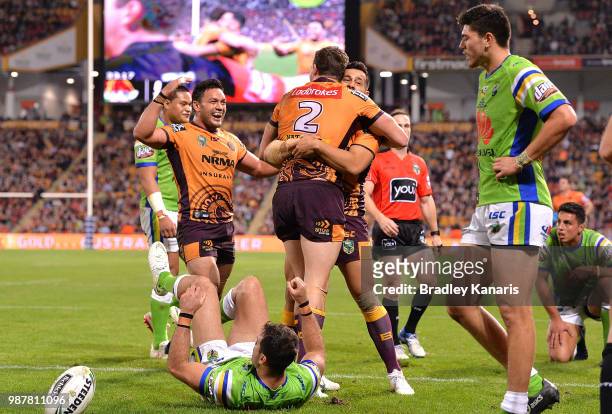 Corey Oates of the Broncos is congratulated by team mates after scoring a try during the round 16 NRL match between the Brisbane Broncos and the...