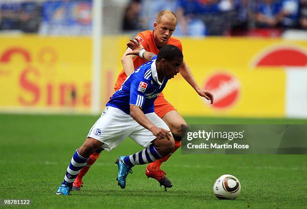 Jefferson Farfan of Schalke and Petri Pasanen of Bremen battle for the ball during the Bundesliga match between FC Schalke 04 and Werder Bremen at...