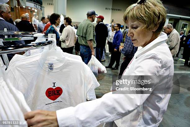 Bonnie Chestunt, a Berkshire Hathaway shareholder for fifteen years, looks over Berkshire Hathaway merchandise on the exhibition floor prior to the...