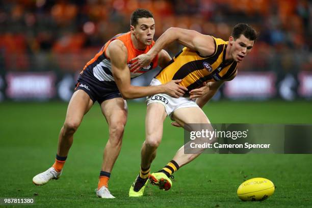 Josh Kelly of the Giants tackles Jaeger O'Meara of the Hawks during the round 15 AFL match between the Greater Western Sydney Giants and the Hawthorn...