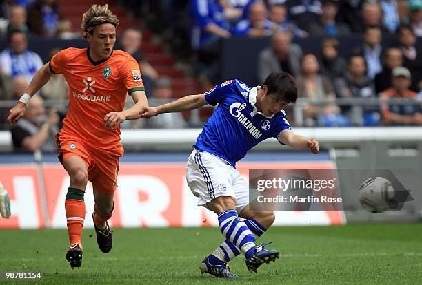 Hao Junmin of Schalke and Clemens Fritz of Bremen battle for the ball during the Bundesliga match between FC Schalke 04 and Werder Bremen at Veltins...