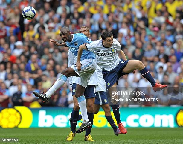 Manchester City's French midfielder Patrick Vieira heads clear from Aston Villa's English midfielder Stewart Downing during the English Premier...