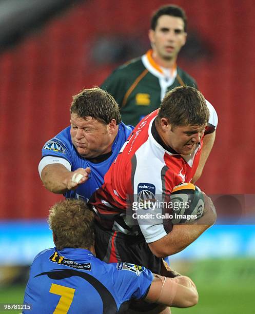 Janse van Rensburg of the Lions is tackled by Matt Dunning and David Pocock of the Force during the Super 14 match between Auto and General Lions and...