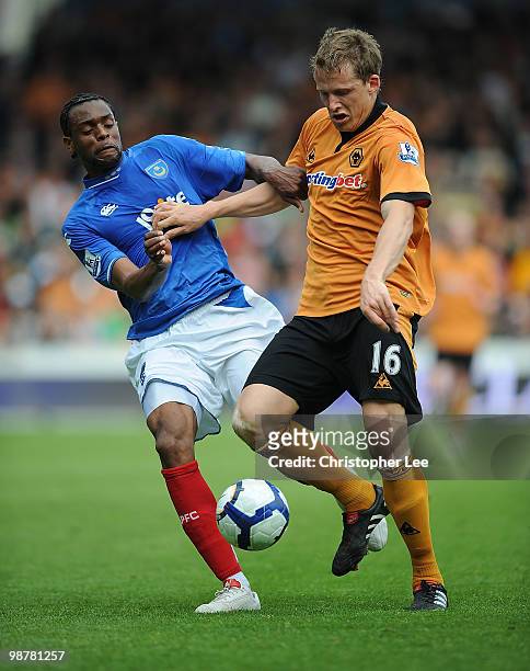Frederic Piquionne of Portsmouth battles with Christophe Berra of Wolves during the Barclays Premier League match between Portsmouth and...