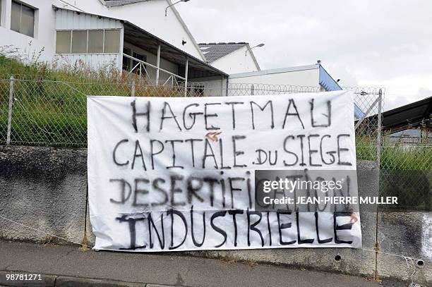 Picture taken on April 30, 2010 in Hagetmau shows a banner fixed up by employees of French manufacture of chairs Capdevielle to protest againt the...