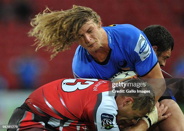 Nick Cummins of the Force is tackled by Deon van Rensburg of the Lions during the Super 14 match between Auto and General Lions and Western Force at...