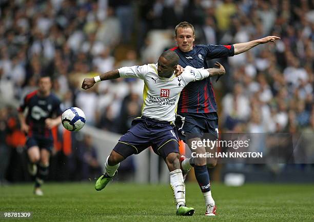 Tottenham's English striker Jermain Defoe vies with Bolton Wanderers' English midfielder Matthew Taylor during the English Premier League football...